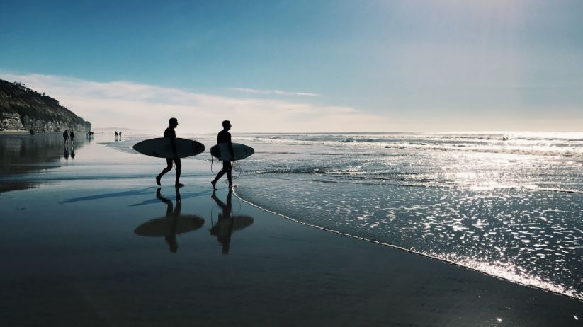 surfers on the beach living their life