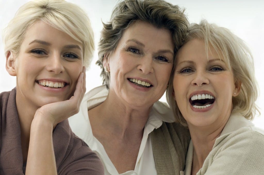 close up of three smiling happy women