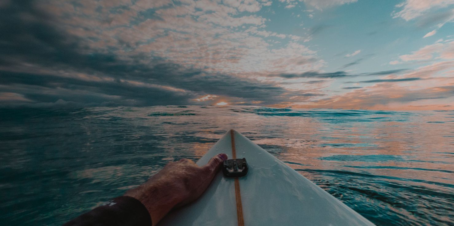 man on surfboard during sunset with improved vision