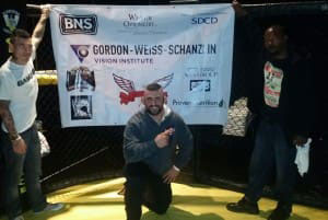 Andy in ring with banner