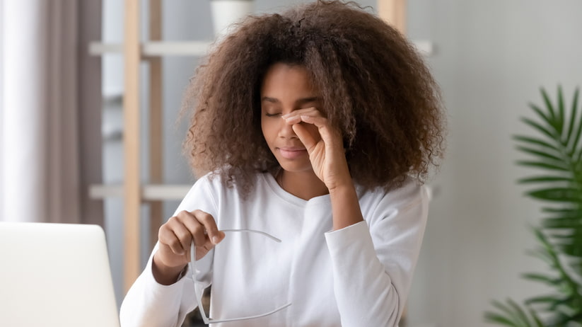 woman rubbing her eyes