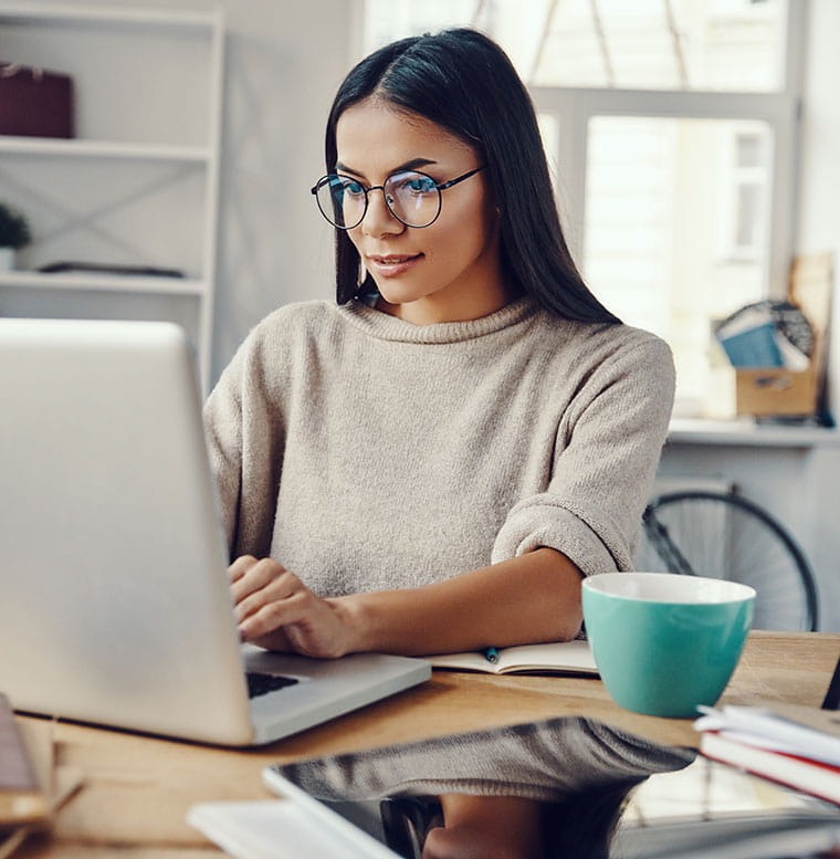 Young woman researching on laptop