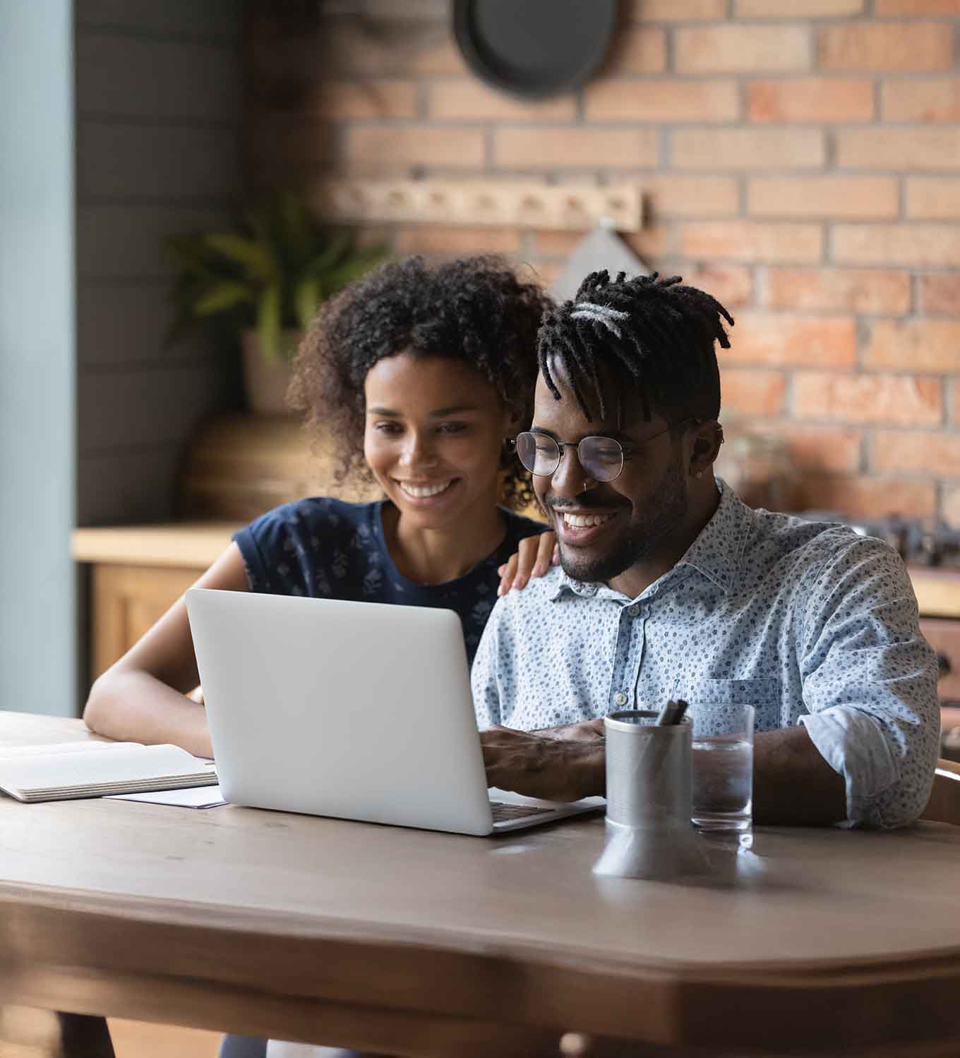 happy young couple looking at the computer
